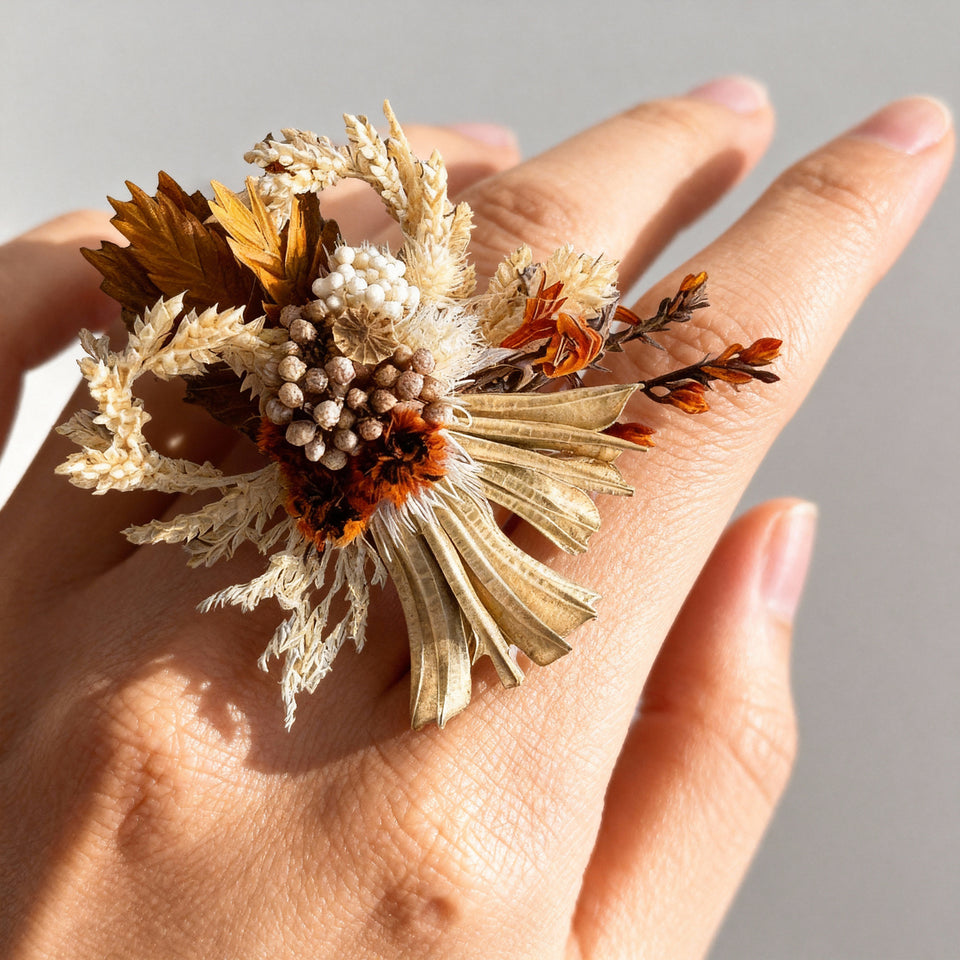 Cream and rust preserved flower ring worn on a hand