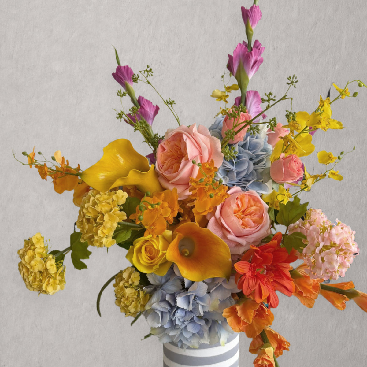 Purple, pink and white artificial flower stems arranged together