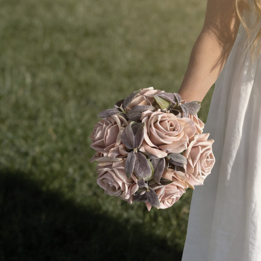 Blush and taupe floral design held outdoors